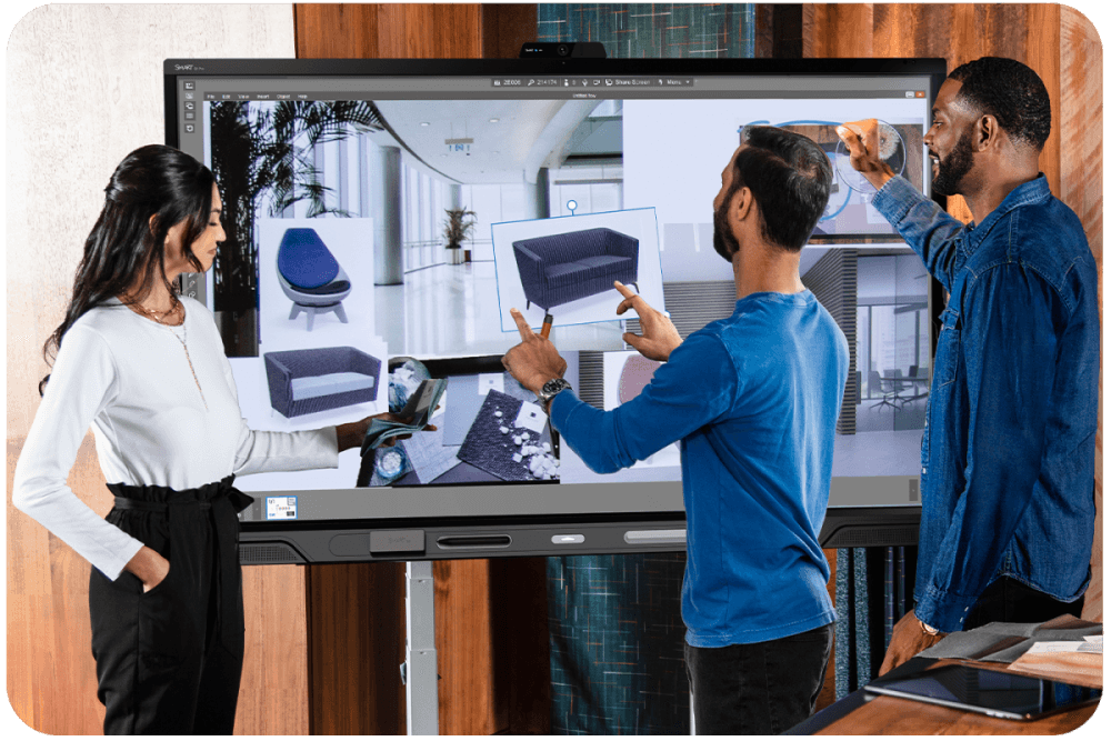 Team of three professionals engaging with QX Pro series interactive display during a collaborative design session.